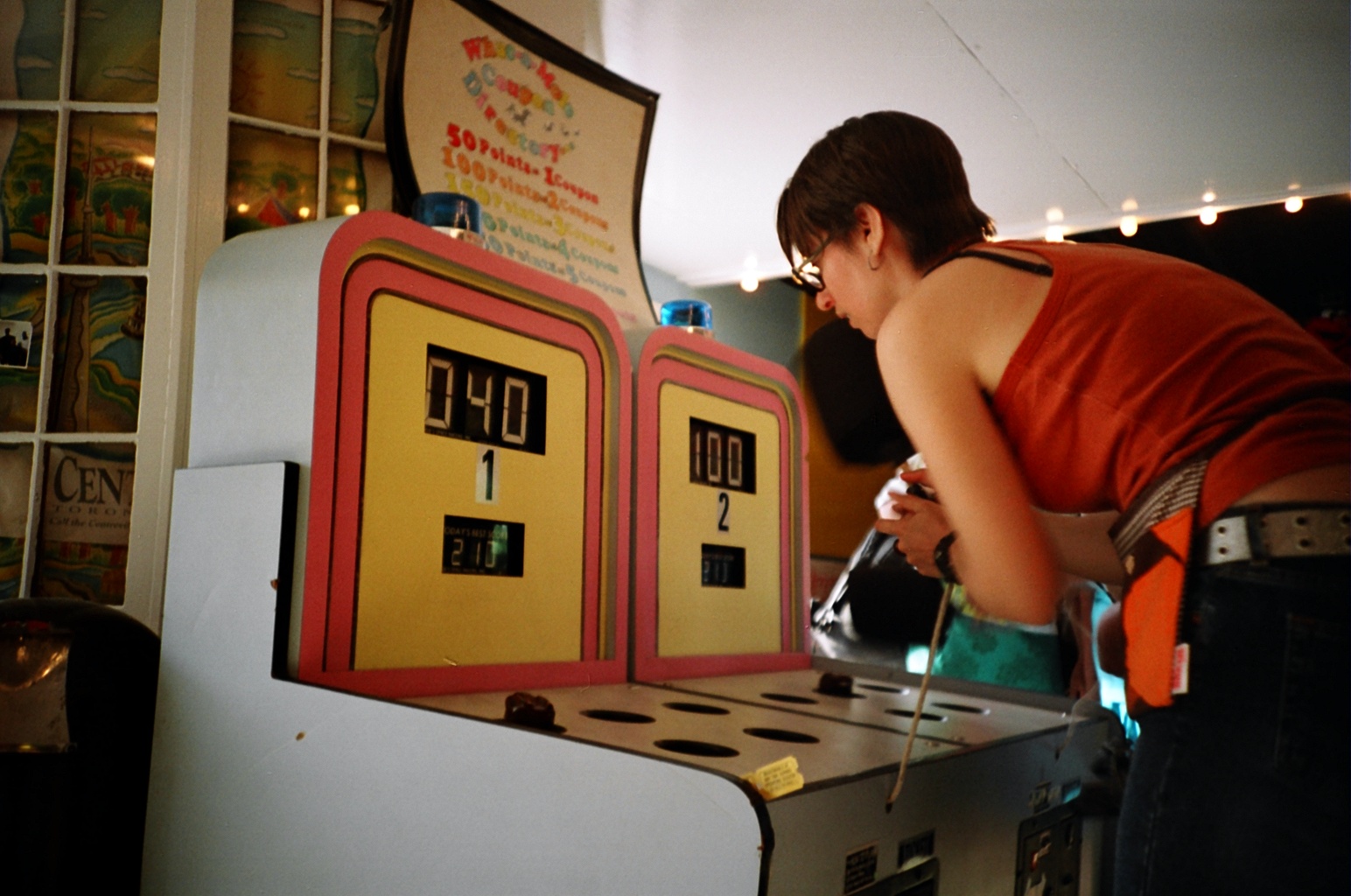 Person playing arcade game where they hit plastic moles.